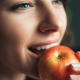 A colorful assortment of fresh fruits and vegetables, including apples, carrots, and leafy greens, symbolizing smile-friendly foods for better oral health